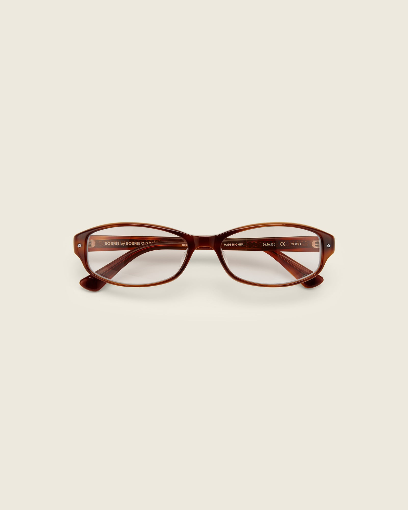 Bonnie Clyde Coco Glasses. Layered brown frames with clear lenses.