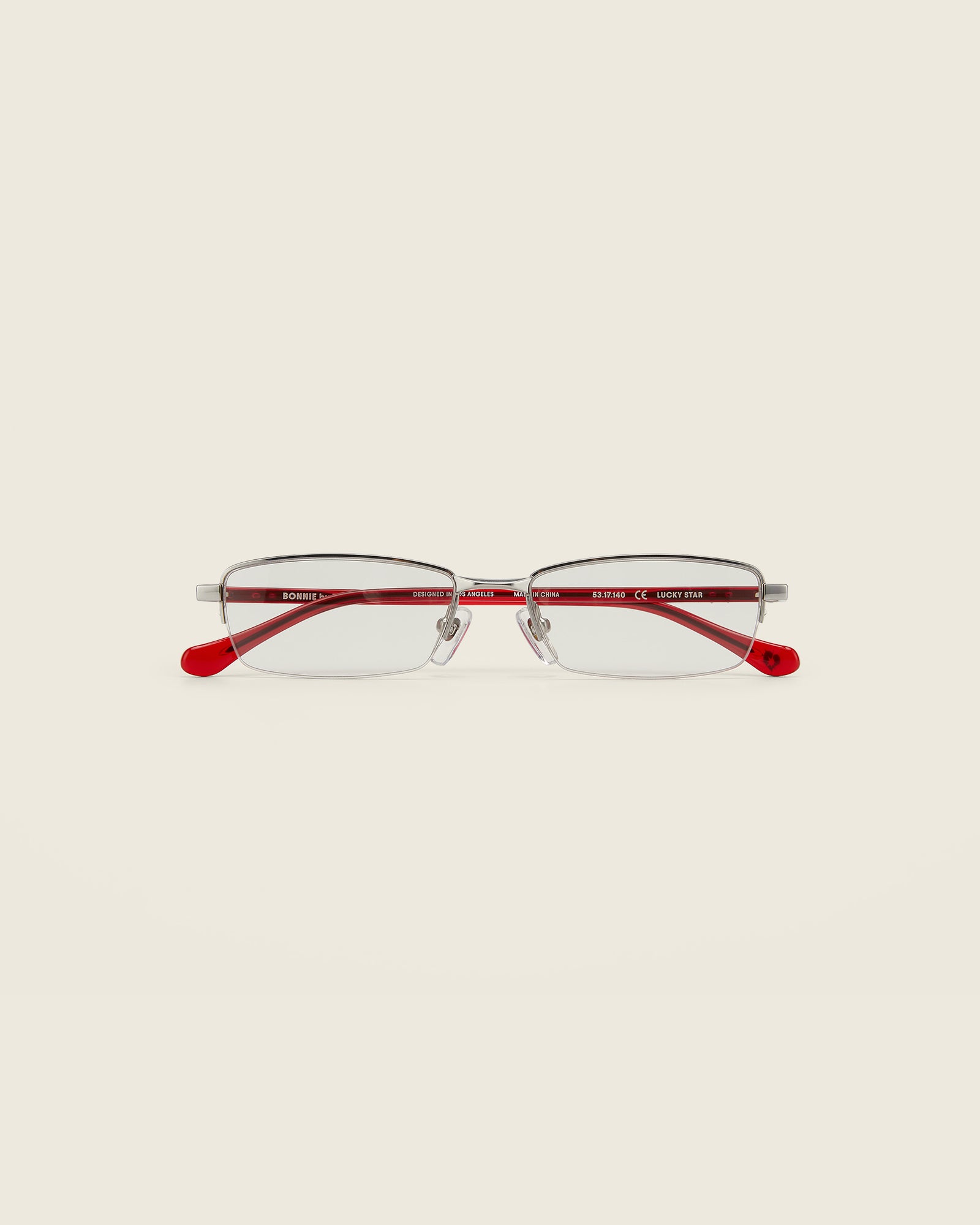 Bonnie Clyde Lucky Star Glasses. Silver frames with clear lenses and red arm temples.